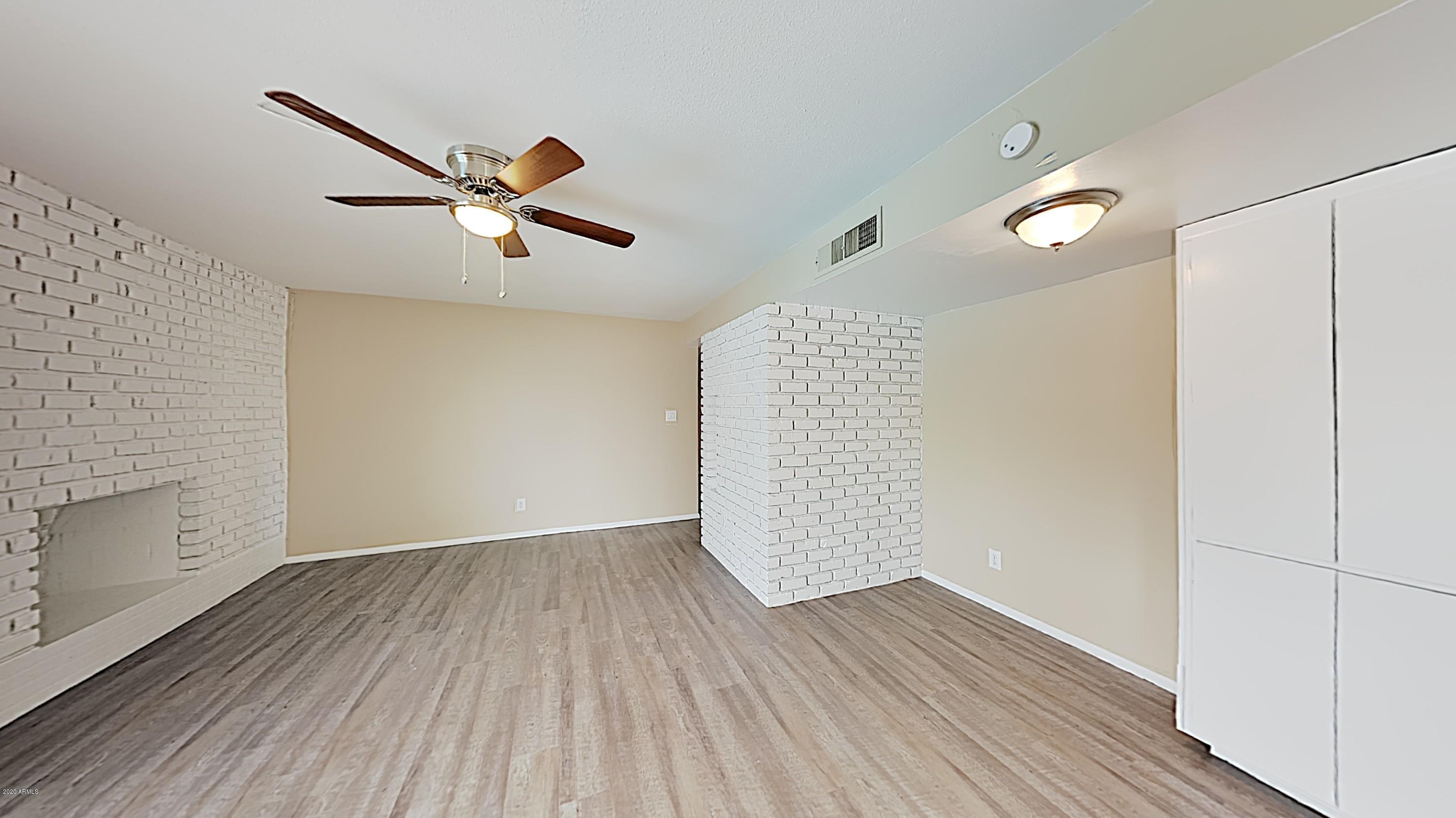 4110 West Hatcher Road Phoenix, AZ 85051 - Photo 5 of 19 a view of empty room with wooden floor