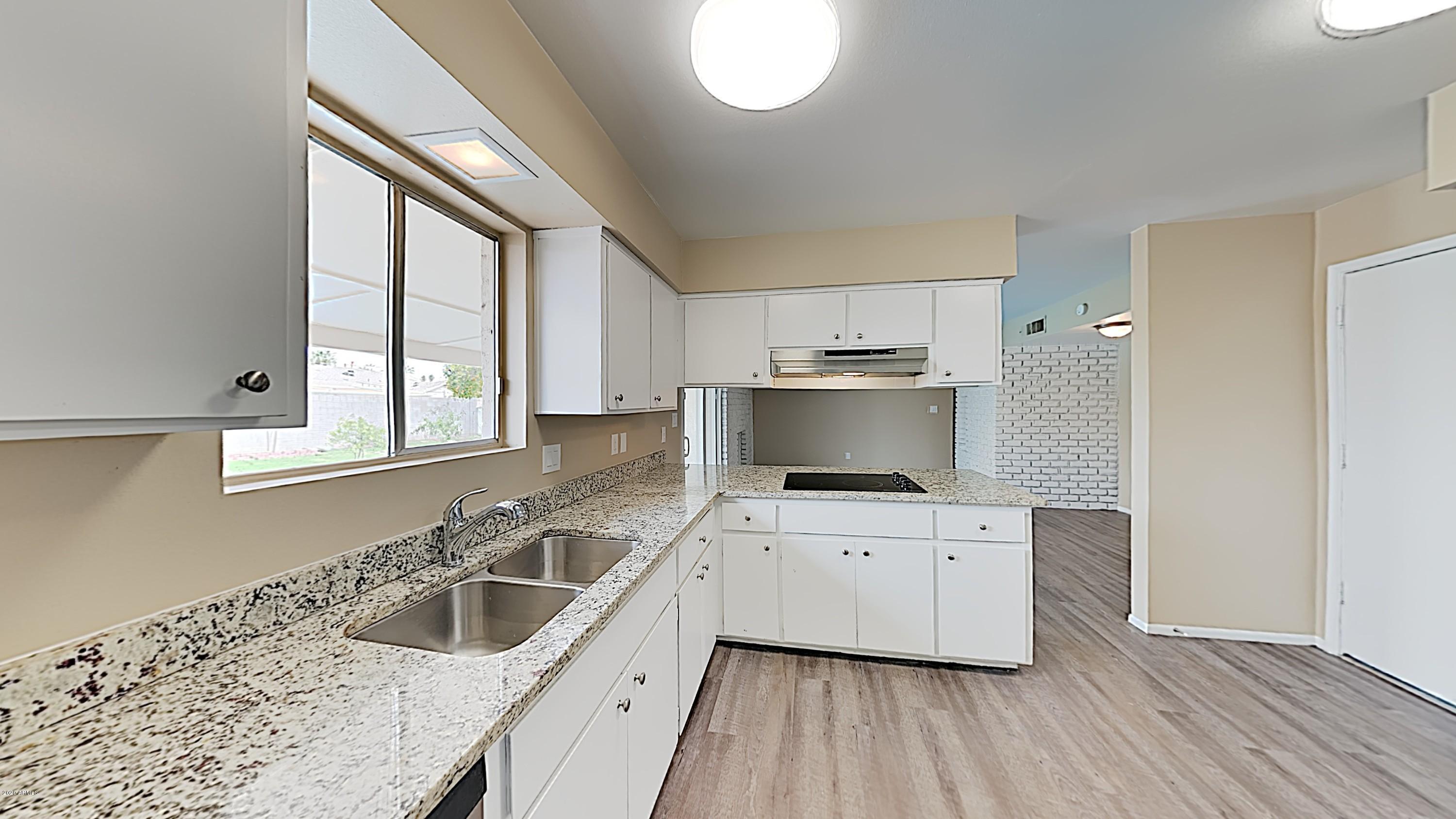 4110 West Hatcher Road Phoenix, AZ 85051 - Photo 8 of 19 a kitchen with a sink cabinets and window