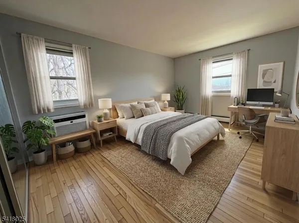 a bedroom with a bed wooden floor and windows