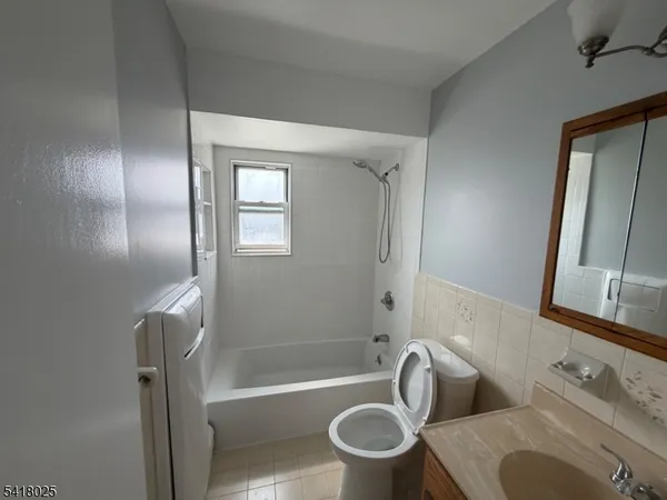 a bathroom with a toilet and a bathtub