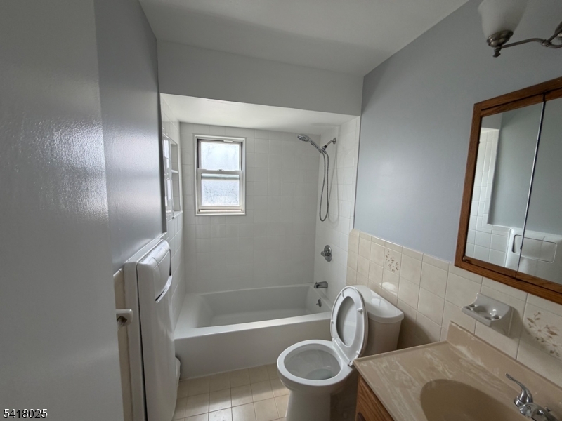 16 Knox Terrace Wayne, NJ 07470 - Photo 4 of 12 a bathroom with a toilet and a bathtub