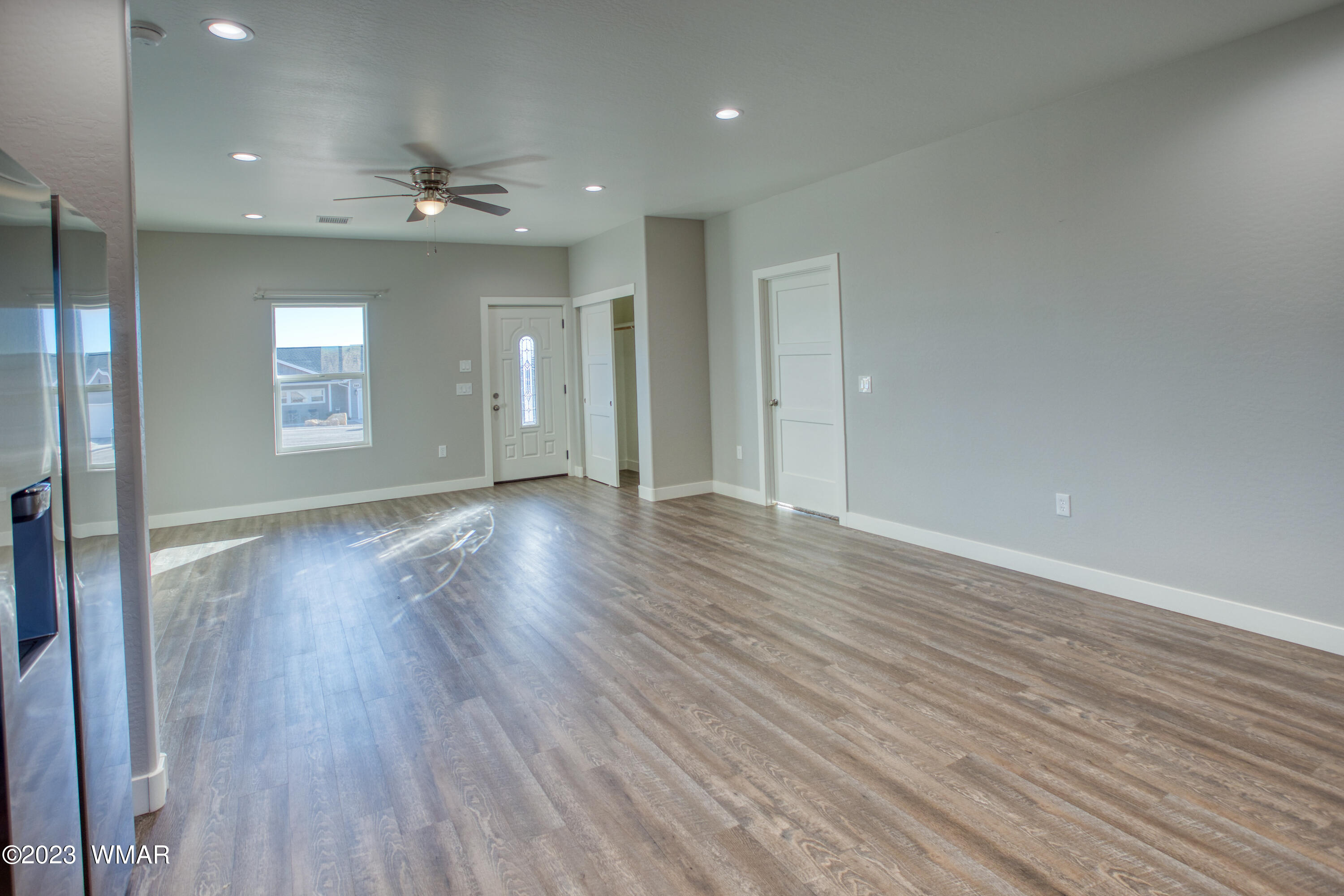 260 Granite Circle Taylor, AZ 85939 - Photo 6 of 11 an empty room with wooden floor and windows