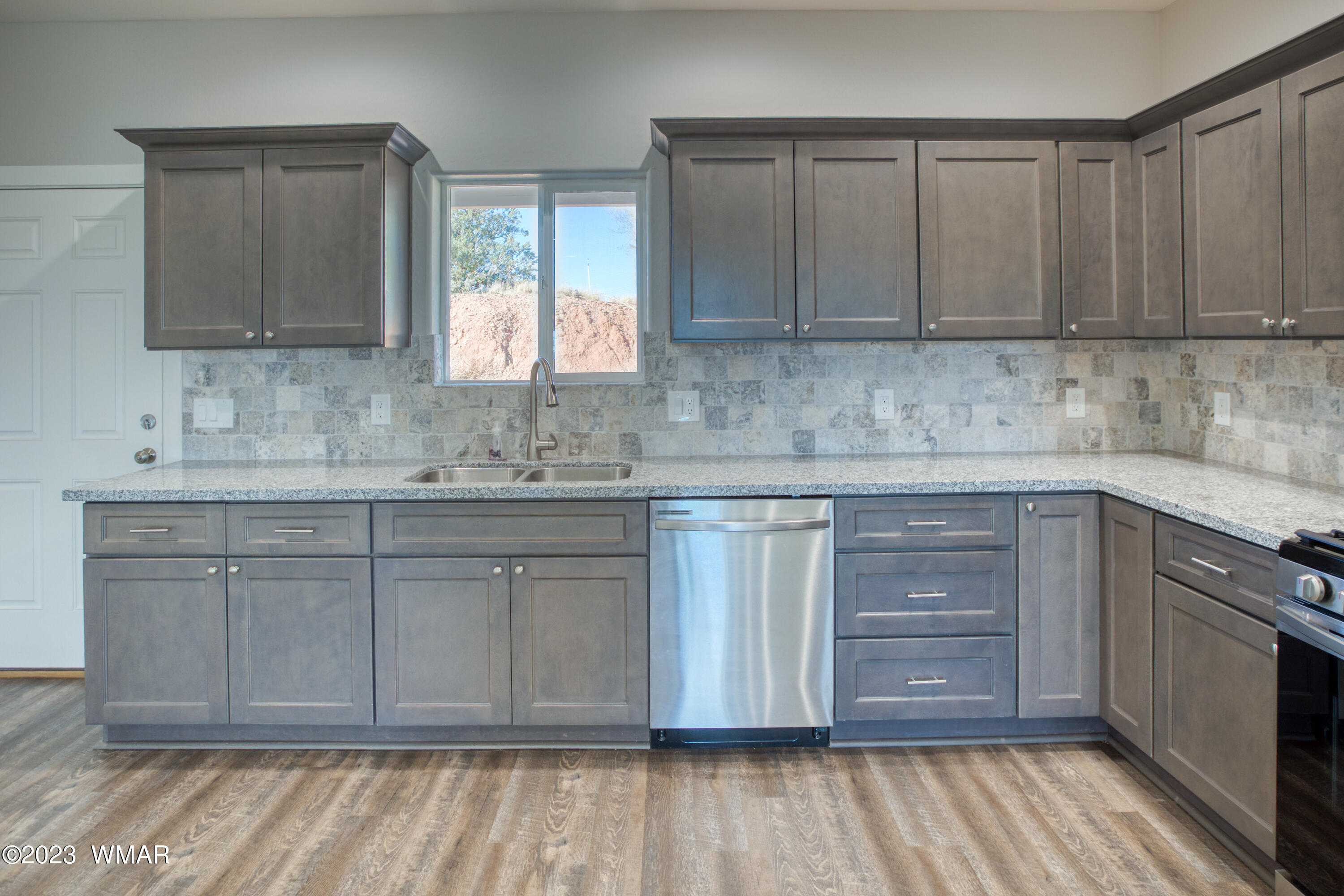 260 Granite Circle Taylor, AZ 85939 - Photo 7 of 11 a kitchen with stainless steel appliances granite countertop a sink and cabinets