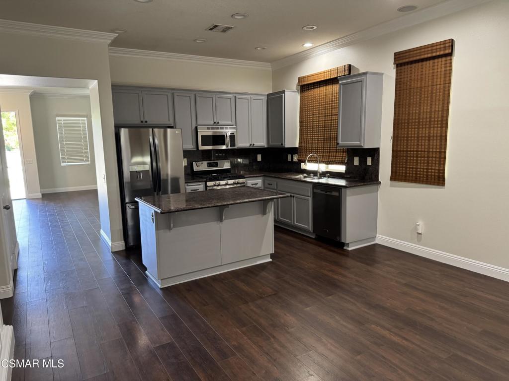1604 Rose Arbor Lane Simi Valley, CA 93065 - Photo 2 of 16 a kitchen with stainless steel appliances granite countertop a refrigerator a stove top oven a sink and dishwasher with wooden floor