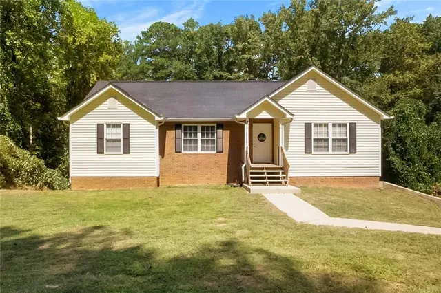 a big house with a big yard and large trees