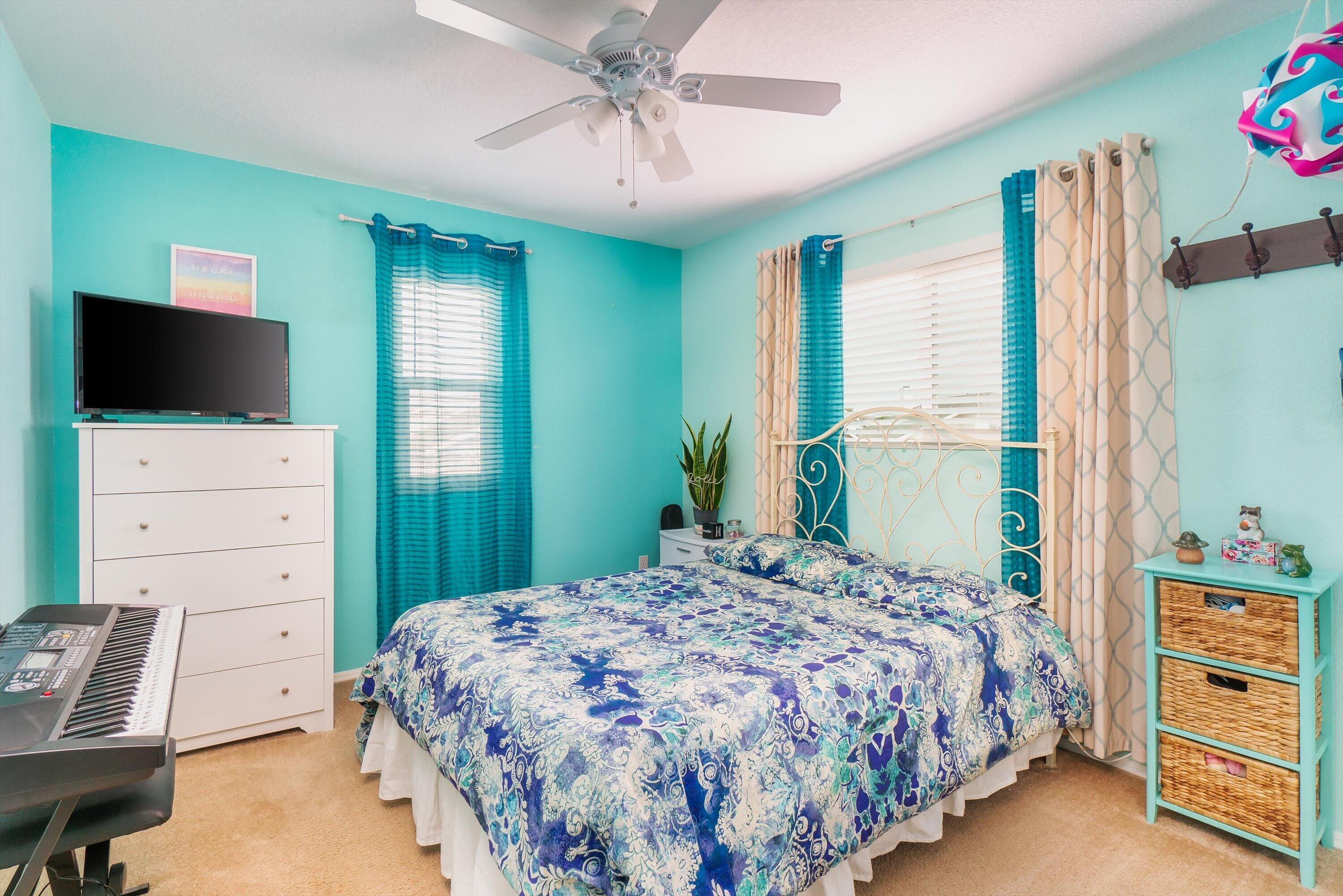 1337 Jason Drive Lompoc, CA 93436 - Photo 17 of 26 a bedroom with a bed and a flat tv screen on dresser