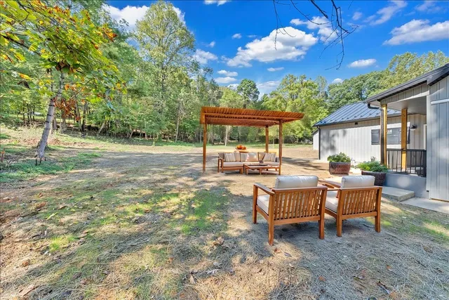 a view of a house with backyard porch and sitting area