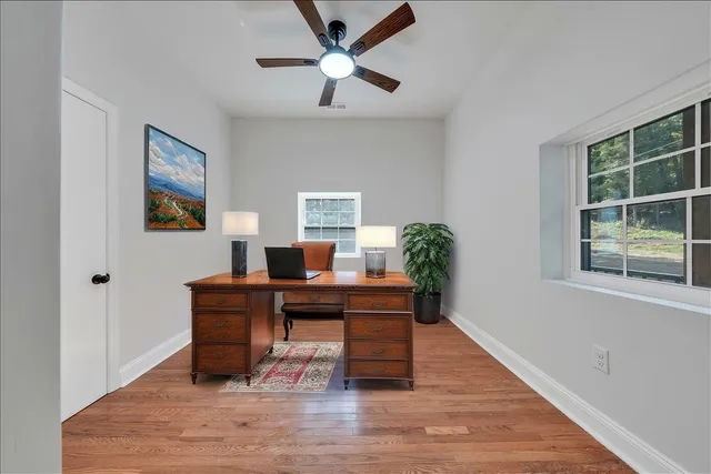 a workspace with furniture window and wooden floor