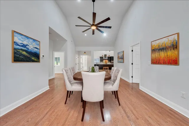 a dining room with furniture window and wooden floor