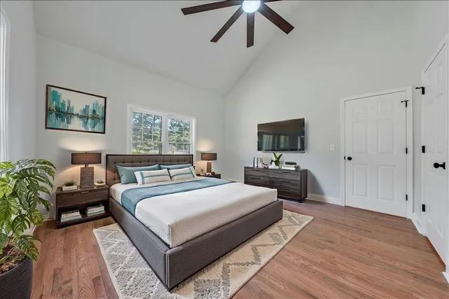 a bedroom with a large bed and a tv