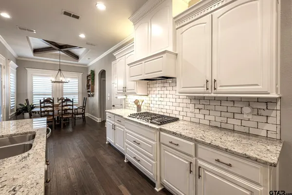 a kitchen with sink stove and cabinets