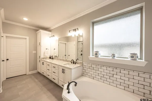 a bathroom with a bathtub and shower