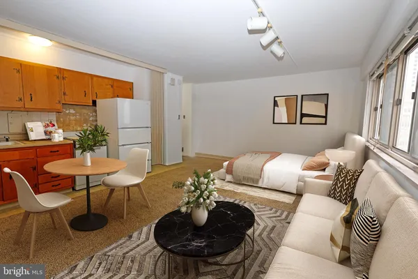 a living room with furniture and a chandelier