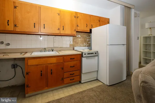 a utility room with cabinets washer and dryer