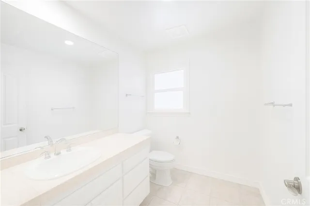 a bathroom with a sink a toilet and vanity