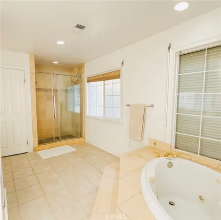 a bathroom with a tub and shower