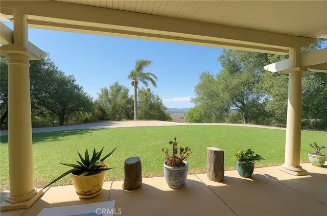 a view of a two chairs next to a yard