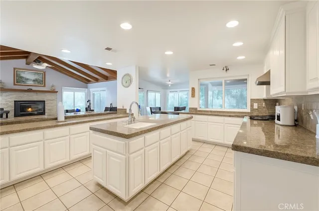 a kitchen with stainless steel appliances granite countertop a sink and cabinets