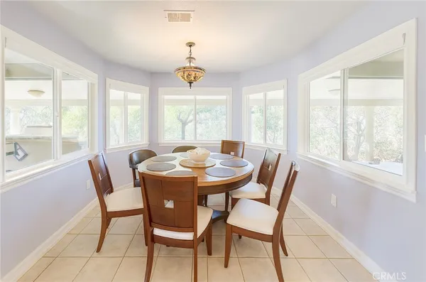 a view of a dining room with furniture large windows and wooden floor