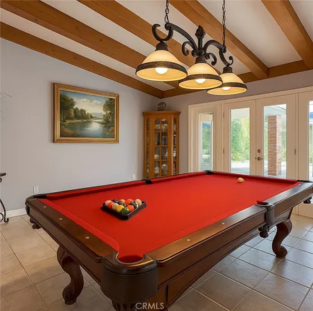 a room with pool table and windows