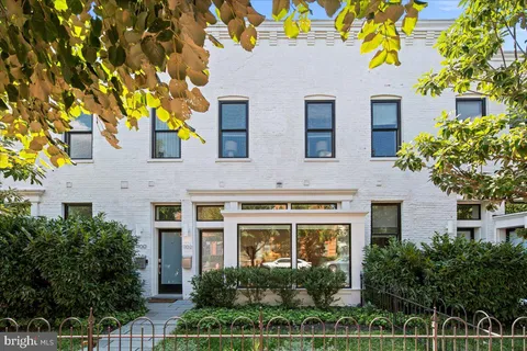 a front view of a house with plants