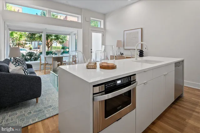 a kitchen with a stove and a white cabinets