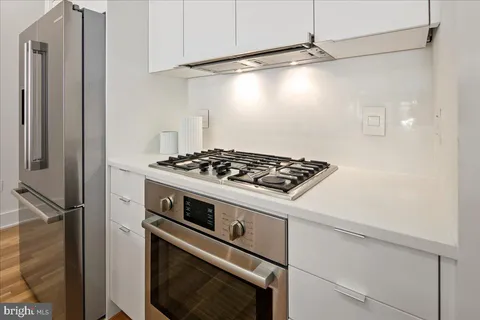 a stove top oven sitting inside of a kitchen