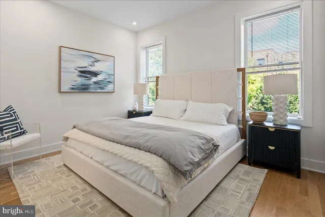 a bedroom with a bed and a painting on the wall