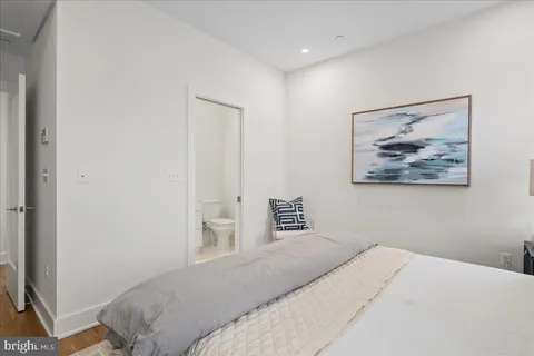 a bedroom with a bed and a wall painting