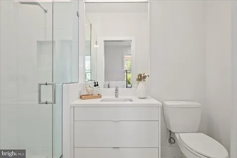 a bathroom with a sink a toilet and mirror
