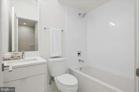 a bathroom with a sink toilet vanity and shower