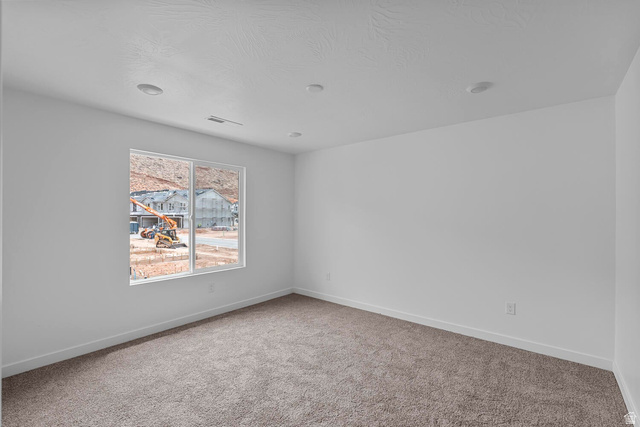 2133 Wolverine Way, Unit 2440 Washington, UT 84780 - Photo 19 of 39 Bright interior space featuring a large window, recessed lighting, white walls, and neutral-toned carpeting