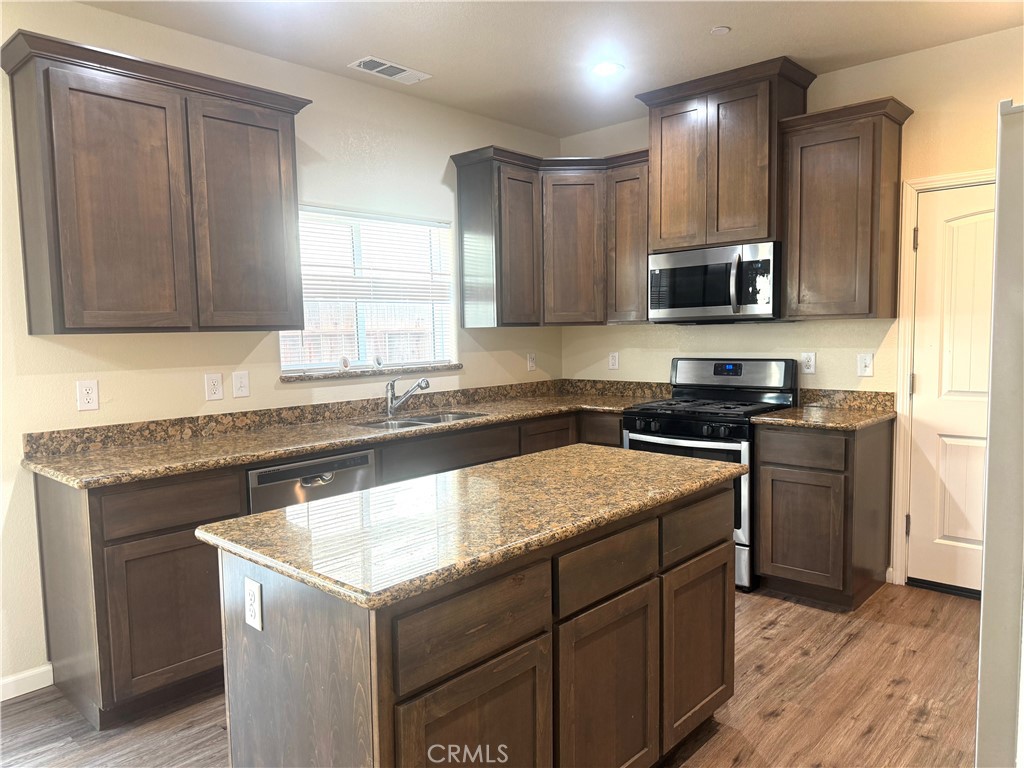 1339 Playa Del Rey Drive Merced, CA 95348 - Photo 6 of 48 a kitchen with a stove sink and microwave