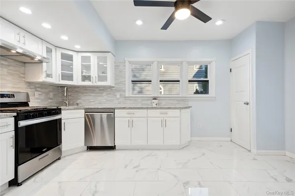 a kitchen with a sink stove and cabinets