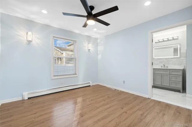 an empty room with a bathroom and a window