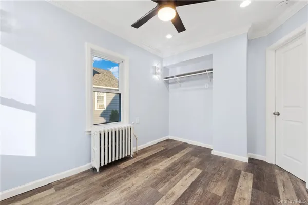 a view of a livingroom with wooden floor and windows