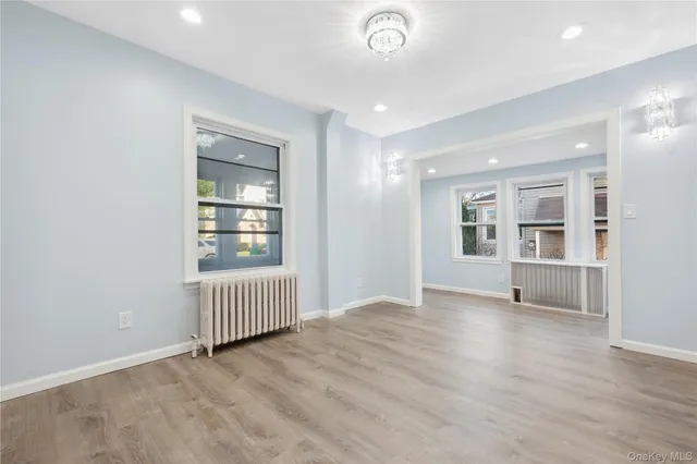 an empty room with windows and closet