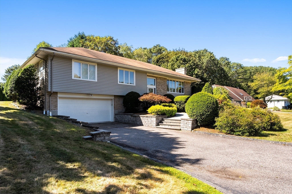 a view of a house with backyard and sitting area