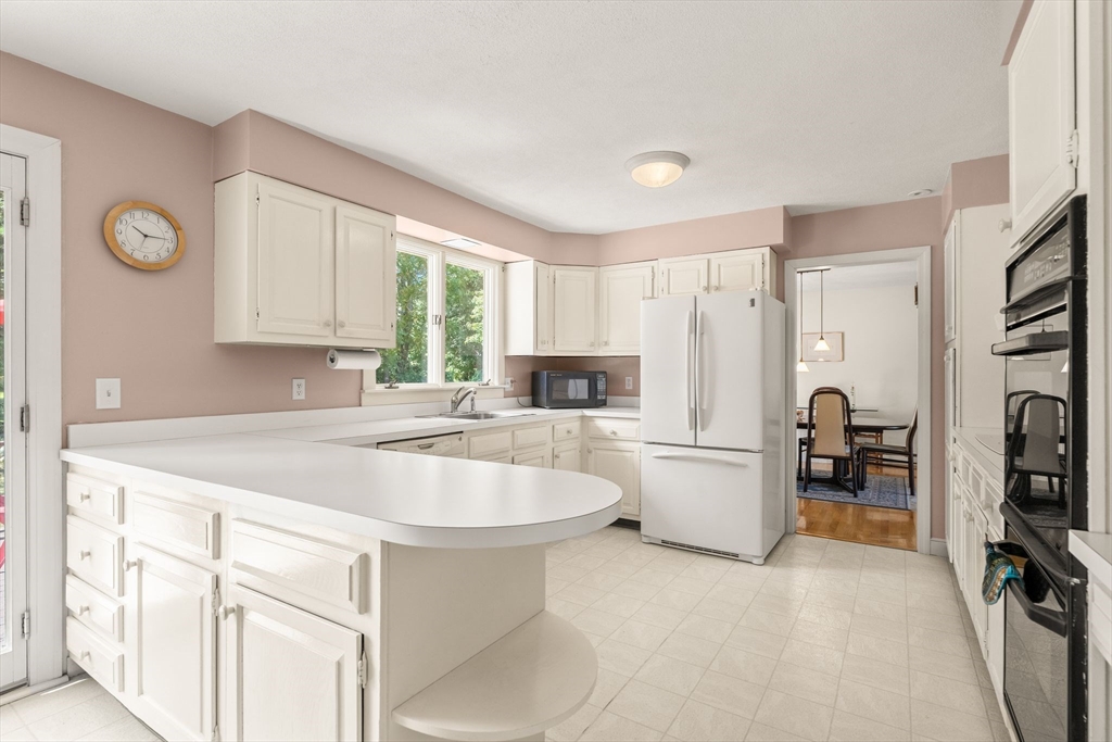 10 Idylwilde Road Lexington, MA 02421 - Photo 14 of 42 a kitchen with refrigerator and window