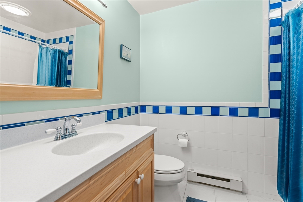 10 Idylwilde Road Lexington, MA 02421 - Photo 19 of 42 a bathroom with a sink a toilet and a mirror