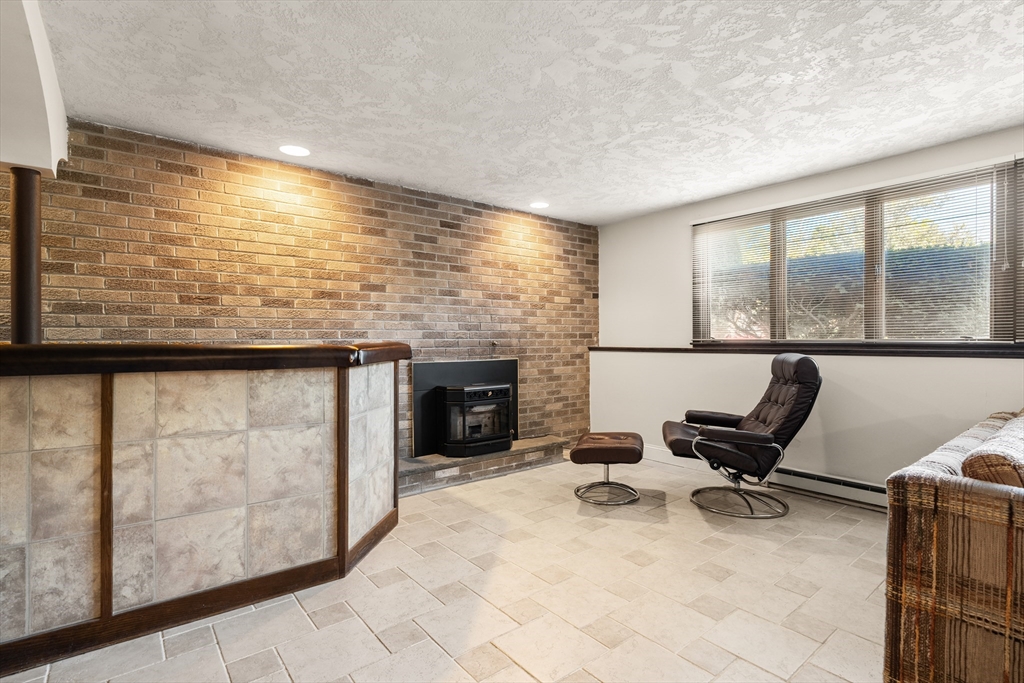 10 Idylwilde Road Lexington, MA 02421 - Photo 29 of 42 a view of a livingroom with furniture and a fireplace