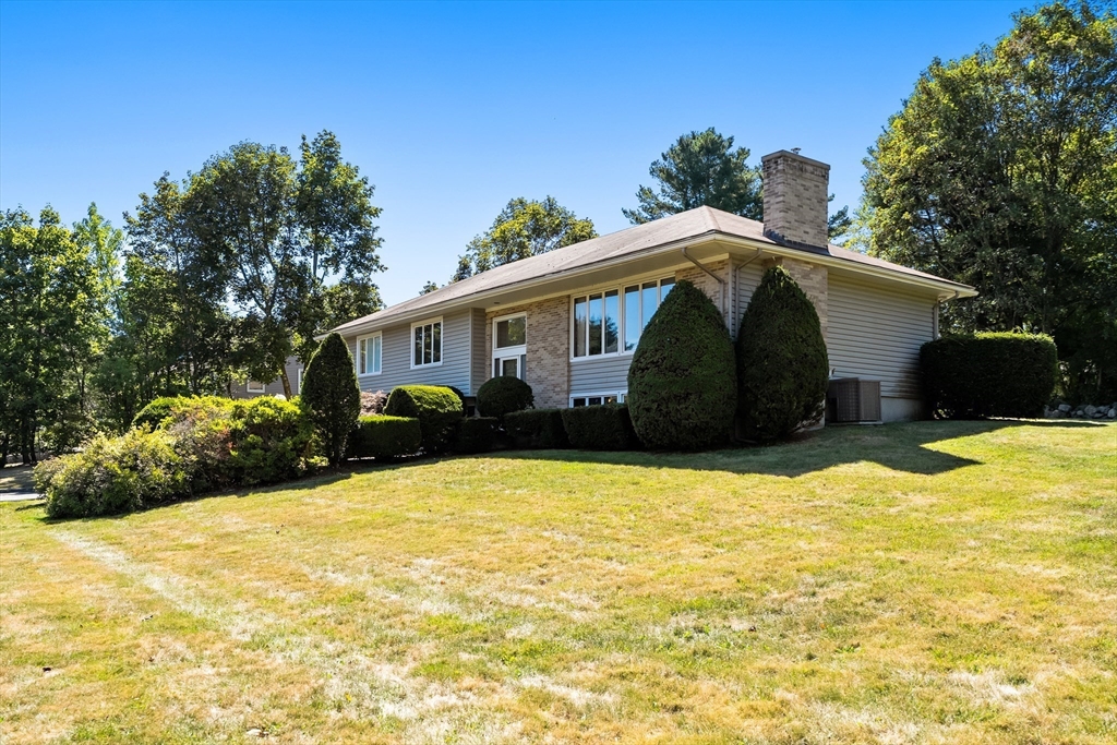 10 Idylwilde Road Lexington, MA 02421 - Photo 3 of 42 a front view of house with yard and trees in the background