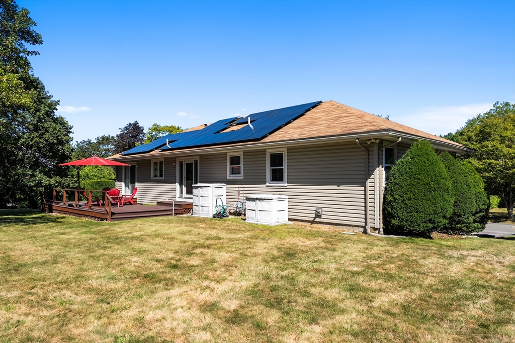 10 Idylwilde Road Lexington, MA 02421 - Photo 38 of 42 a view of a house with a patio and a yard