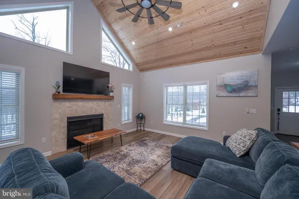 a view of a dining room with furniture a kitchen and chandelier