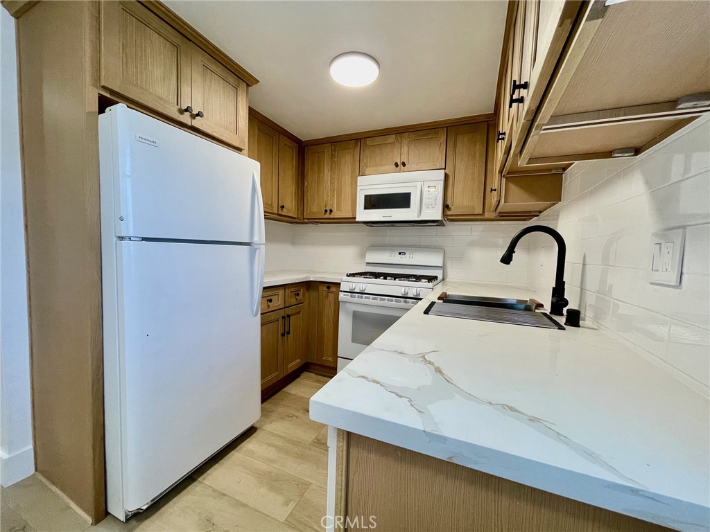 821 Calle Puente, Unit 3 San Clemente, CA 92672 - Photo 2 of 11 a kitchen with a refrigerator and a sink