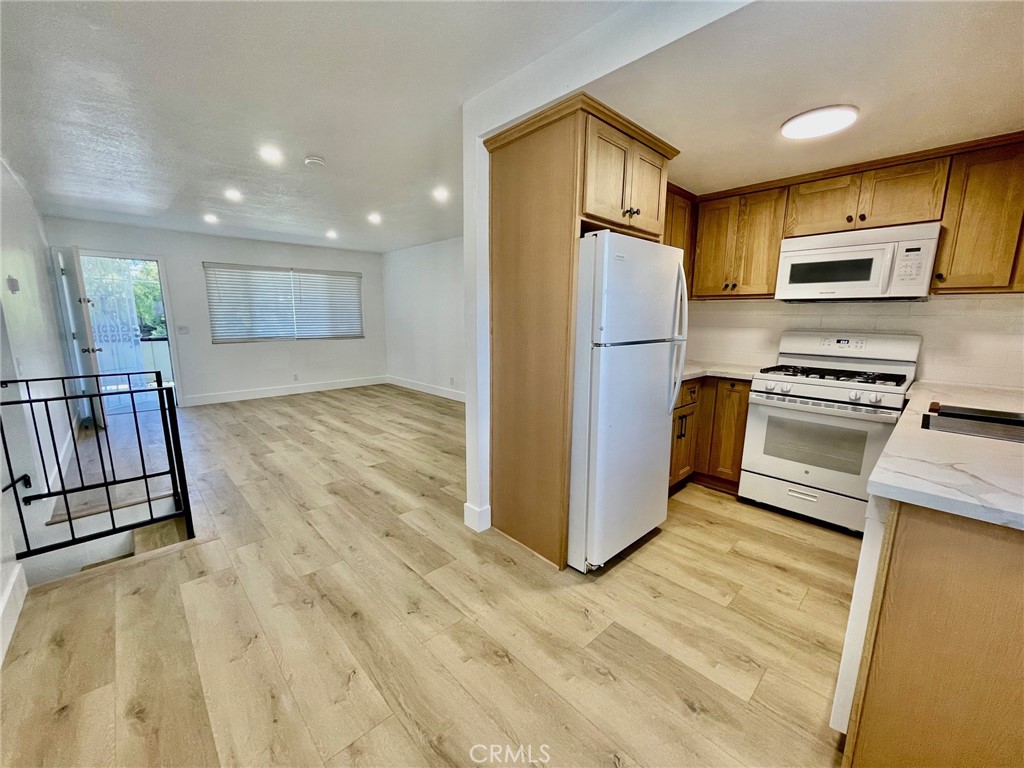 821 Calle Puente, Unit 3 San Clemente, CA 92672 - Photo 9 of 11 a kitchen with stainless steel appliances a refrigerator and a stove top oven