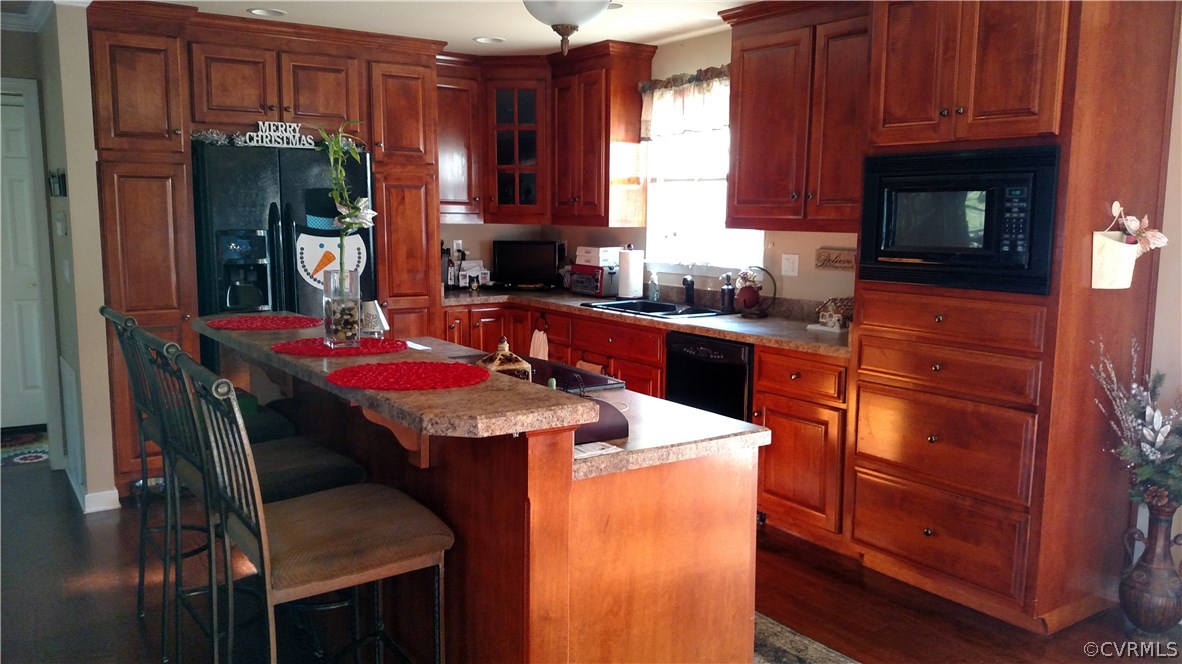4267 Tatum Road Disputanta, VA 23842 - Photo 13 of 24 a kitchen with a sink refrigerator and cabinets