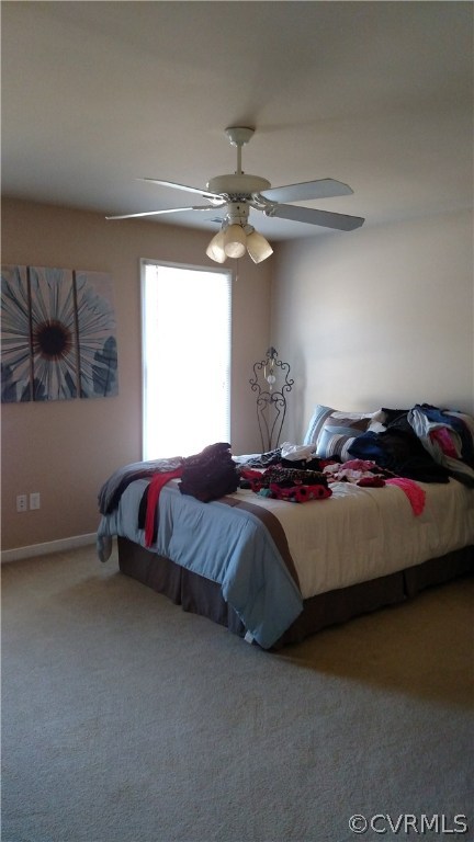 4267 Tatum Road Disputanta, VA 23842 - Photo 20 of 24 a bedroom with a bed and a chandelier