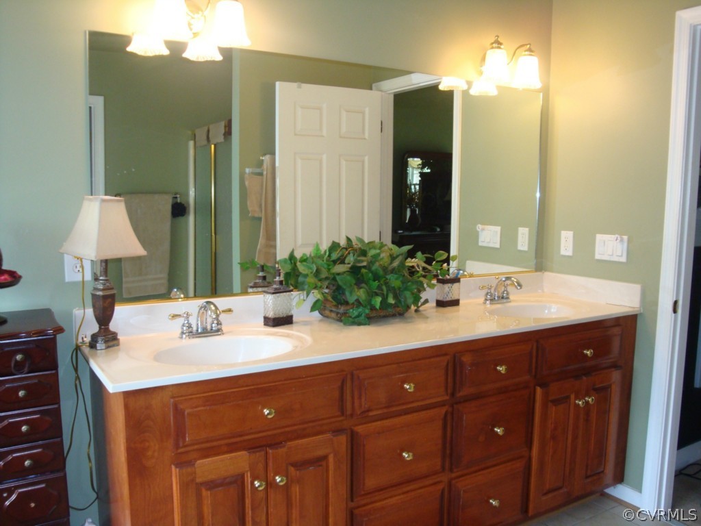 4267 Tatum Road Disputanta, VA 23842 - Photo 8 of 24 a bathroom with a sink vanity and a mirror