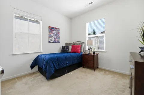 a spacious bedroom with a bed and window